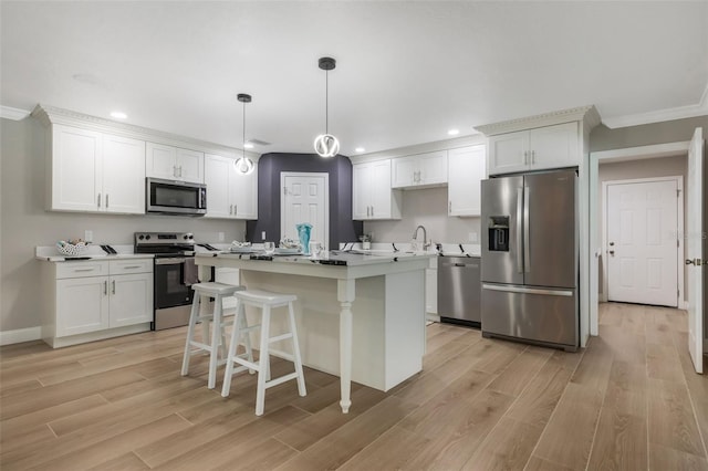 102 Linda Ln, Lake Mary, FL 32746 - kitchen featuring appliances with stainless steel finishes, light wood-style floors, recessed lighting, a kitchen breakfast bar, and a center island