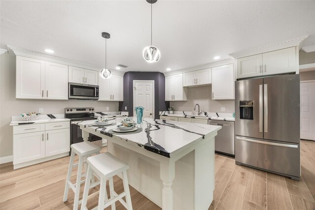 102 Linda Ln, Lake Mary, FL 32746 - kitchen with stainless steel appliances, recessed lighting, light wood-style floors, light countertops, and a kitchen bar