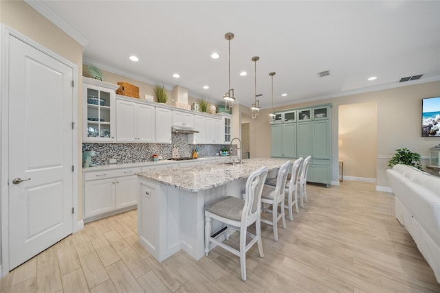 1962 Flora Pass Pl, Kissimmee, FL 34747 - kitchen with cooktop, crown molding, recessed lighting, tasteful backsplash, and white cabinetry
