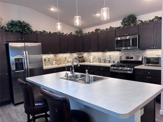3328 Davis Ter, The Villages, FL 32163 - kitchen with stainless steel appliances, lofted ceiling, light countertops, tasteful backsplash, and a breakfast bar area