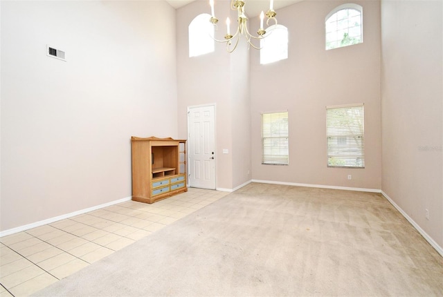 9223 Leeland Archer Blvd, Orlando, FL 32836 - unfurnished living room featuring a towering ceiling, a chandelier, and light colored carpet