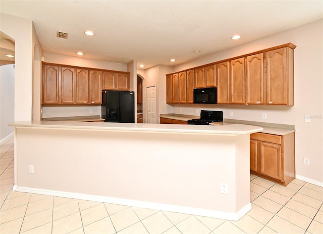 9223 Leeland Archer Blvd, Orlando, FL 32836 - kitchen with black appliances, arched walkways, recessed lighting, light countertops, and light tile patterned flooring