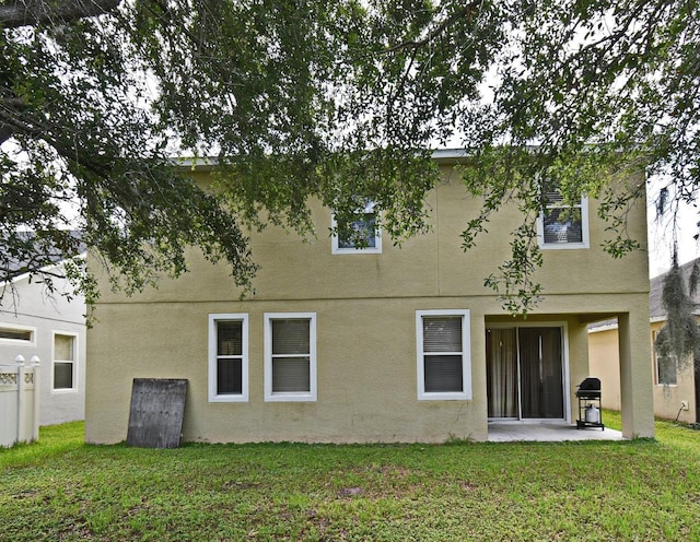 9223 Leeland Archer Blvd, Orlando, FL 32836 - rear view of house with stucco siding, a patio, and a yard