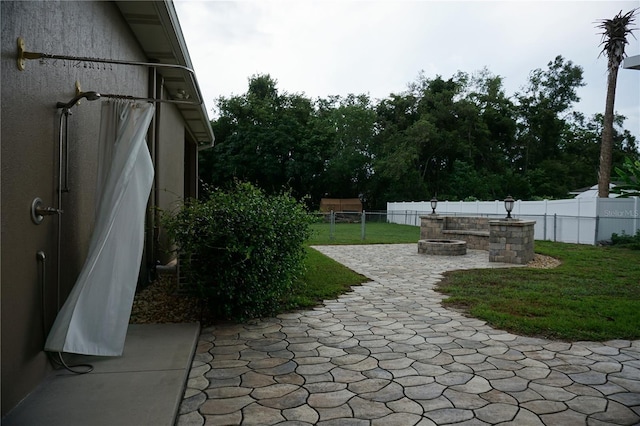 13785 SE 39th Ter, Summerfield, FL 34491 - fenced backyard featuring a patio and an outdoor fire pit