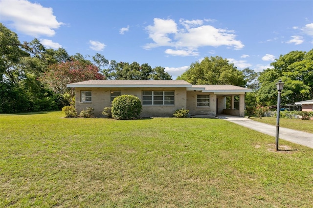 146 Mills Rd, Deland, FL 32724 - ranch-style house with an attached carport, driveway, and a front yard