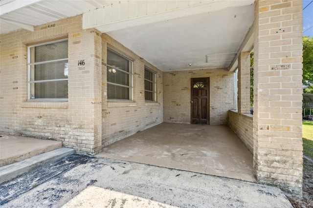 146 Mills Rd, Deland, FL 32724 - property entrance with brick siding and an attached carport