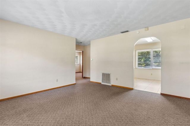 146 Mills Rd, Deland, FL 32724 - spare room featuring arched walkways and light carpet
