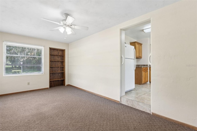 146 Mills Rd, Deland, FL 32724 - empty room featuring light carpet, a ceiling fan, and built in shelves