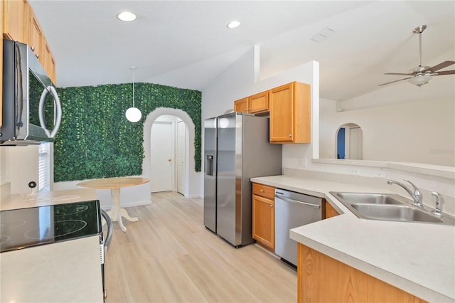 16603 Corner Lake Dr, Orlando, FL 32820 - kitchen with appliances with stainless steel finishes, vaulted ceiling, arched walkways, light wood finished floors, and light countertops