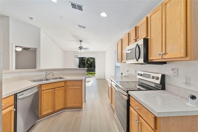 16603 Corner Lake Dr, Orlando, FL 32820 - kitchen with stainless steel appliances, ceiling fan, light wood-style floors, and light countertops