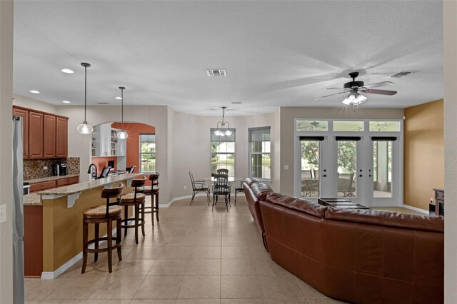 480 Buckhorn Dr, Winter Springs, FL 32708 - living room with recessed lighting, a ceiling fan, light tile patterned floors, arched walkways, and a chandelier
