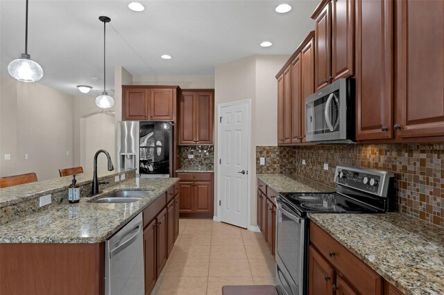 480 Buckhorn Dr, Winter Springs, FL 32708 - kitchen with stainless steel appliances, light tile patterned floors, decorative light fixtures, tasteful backsplash, and recessed lighting