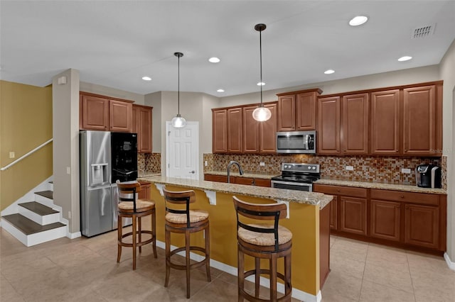 480 Buckhorn Dr, Winter Springs, FL 32708 - kitchen with stainless steel appliances, a kitchen island with sink, light stone counters, pendant lighting, and a breakfast bar area