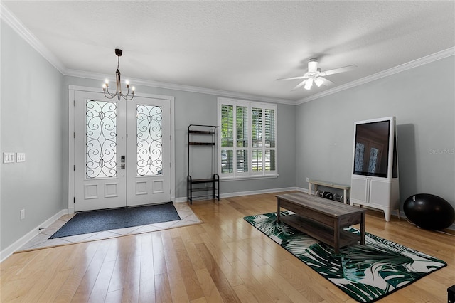 207 Via Tuscany Loop, Lake Mary, FL 32746 - foyer featuring a chandelier, wood finished floors, ornamental molding, a ceiling fan, and a textured ceiling