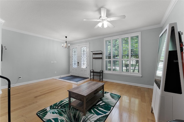 207 Via Tuscany Loop, Lake Mary, FL 32746 - living room with light wood-style floors, a chandelier, ceiling fan, ornamental molding, and a textured ceiling