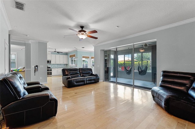 207 Via Tuscany Loop, Lake Mary, FL 32746 - living area featuring ceiling fan, crown molding, light wood-style floors, and a textured ceiling