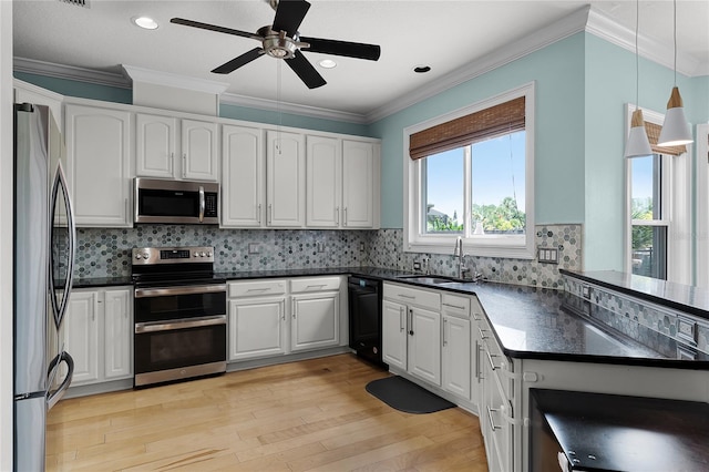 207 Via Tuscany Loop, Lake Mary, FL 32746 - kitchen featuring stainless steel appliances, dark countertops, ceiling fan, white cabinets, and light wood-style floors