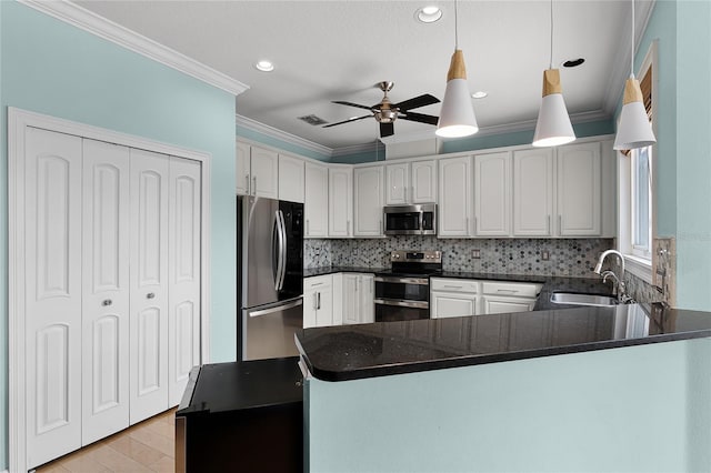 207 Via Tuscany Loop, Lake Mary, FL 32746 - kitchen with appliances with stainless steel finishes, a peninsula, crown molding, a ceiling fan, and recessed lighting