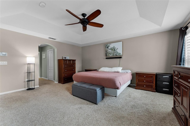 207 Via Tuscany Loop, Lake Mary, FL 32746 - bedroom featuring a tray ceiling, carpet, arched walkways, and ceiling fan