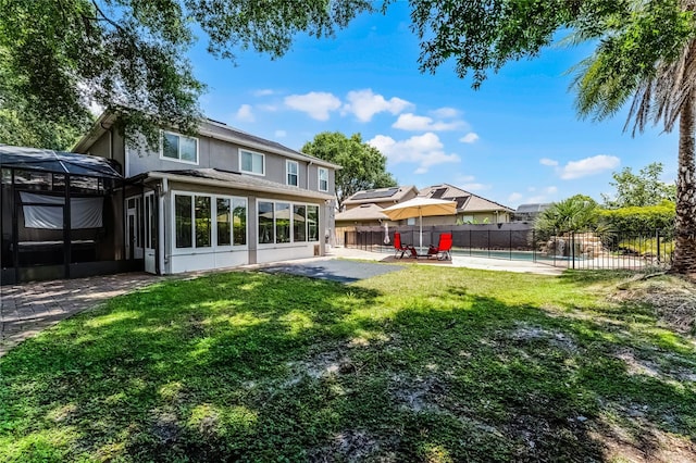 207 Via Tuscany Loop, Lake Mary, FL 32746 - back of property with a patio area, a sunroom, a pool, and stucco siding