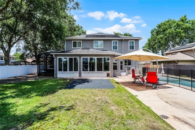 207 Via Tuscany Loop, Lake Mary, FL 32746 - back of property featuring a sunroom, a patio area, a fenced backyard, and stucco siding