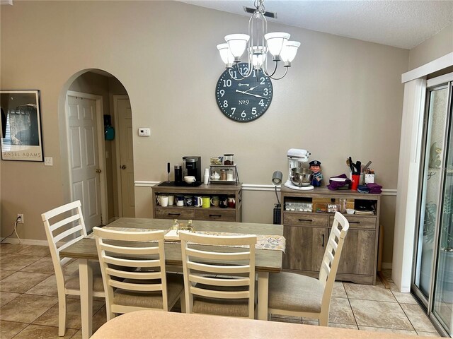 734 La Costa St, Minneola, FL 34715 - dining room with arched walkways, a chandelier, and light tile patterned floors