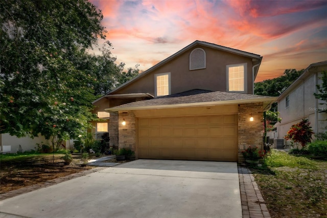 1039 Eagles Forrest Dr, Apopka, FL 32712 - traditional-style home with stone siding, concrete driveway, stucco siding, and an attached garage