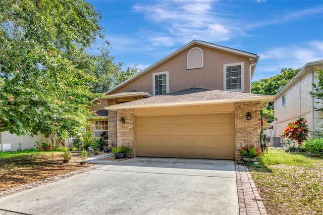 1039 Eagles Forrest Dr, Apopka, FL 32712 - view of front of home with brick siding, concrete driveway, an attached garage, and stucco siding