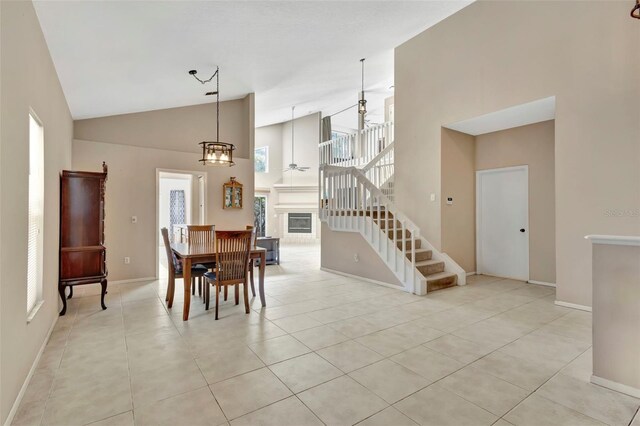 1039 Eagles Forrest Dr, Apopka, FL 32712 - dining area with high vaulted ceiling, stairway, light tile patterned floors, and a ceiling fan