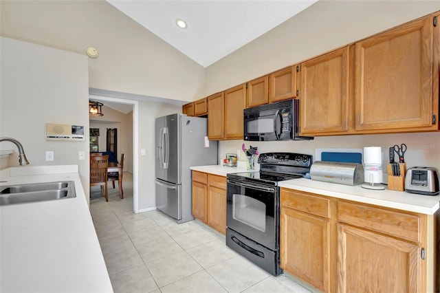 1039 Eagles Forrest Dr, Apopka, FL 32712 - kitchen with black appliances, light tile patterned flooring, vaulted ceiling, light countertops, and recessed lighting