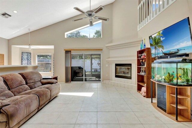 1039 Eagles Forrest Dr, Apopka, FL 32712 - tiled living room with a ceiling fan, high vaulted ceiling, a tiled fireplace, healthy amount of natural light, and recessed lighting