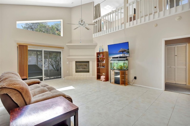 1039 Eagles Forrest Dr, Apopka, FL 32712 - tiled living area featuring a high ceiling, ceiling fan, and a tiled fireplace