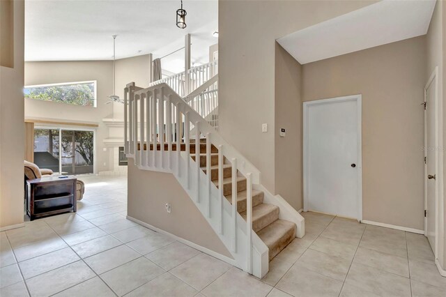 1039 Eagles Forrest Dr, Apopka, FL 32712 - stairs with a high ceiling, plenty of natural light, and tile patterned floors