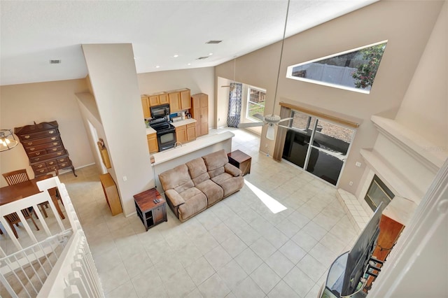 1039 Eagles Forrest Dr, Apopka, FL 32712 - living room with high vaulted ceiling, light tile patterned floors, and a glass covered fireplace