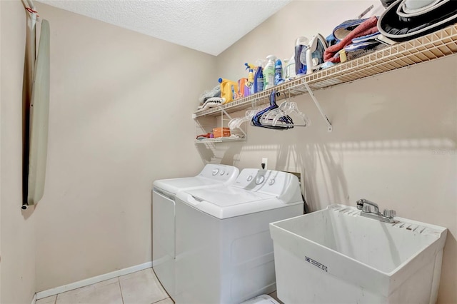 1039 Eagles Forrest Dr, Apopka, FL 32712 - laundry room with independent washer and dryer, light tile patterned flooring, and a textured ceiling