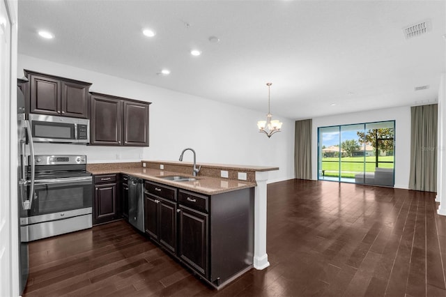 8970 Azalea Sands Ln Unit 2302, Davenport, FL 33896 - kitchen featuring stainless steel appliances, a chandelier, open floor plan, a peninsula, and dark wood finished floors