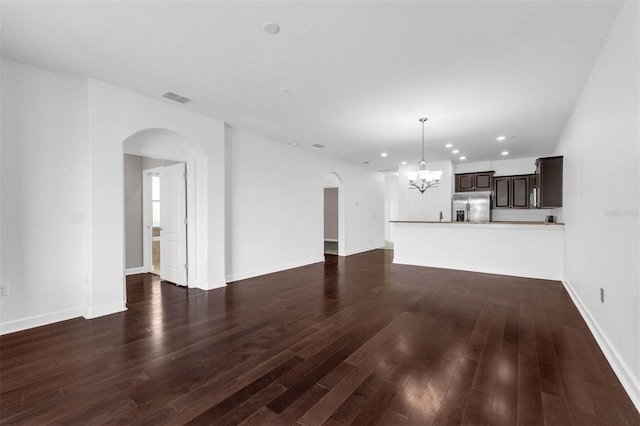 8970 Azalea Sands Ln Unit 2302, Davenport, FL 33896 - unfurnished living room with arched walkways, a chandelier, dark wood-type flooring, and recessed lighting