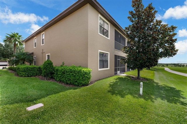 8970 Azalea Sands Ln Unit 2302, Davenport, FL 33896 - view of property exterior with stucco siding and a yard