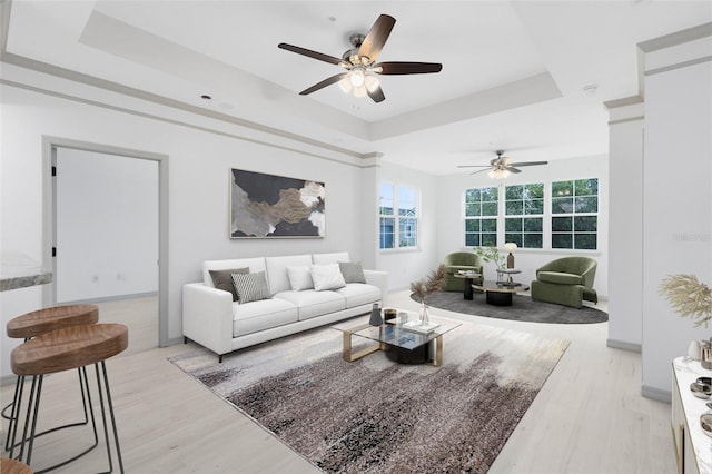 3280 Soho St Unit 306, Orlando, FL 32835 - living room featuring a tray ceiling, light wood-style flooring, and ceiling fan