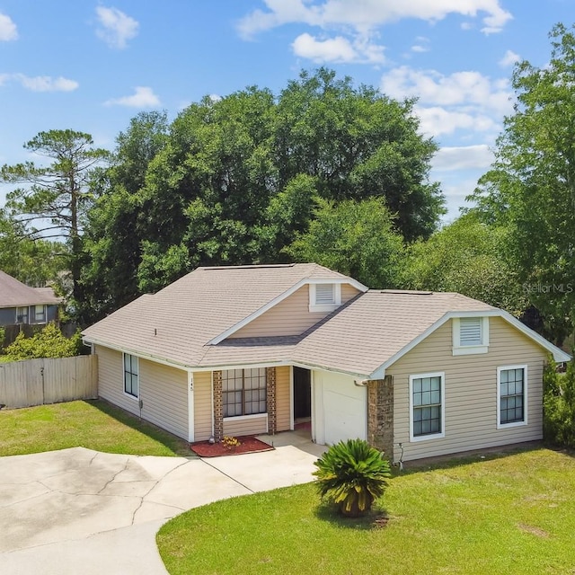 145 Lakeside Cir, Sanford, FL 32773 - traditional home with driveway, an attached garage, and a shingled roof