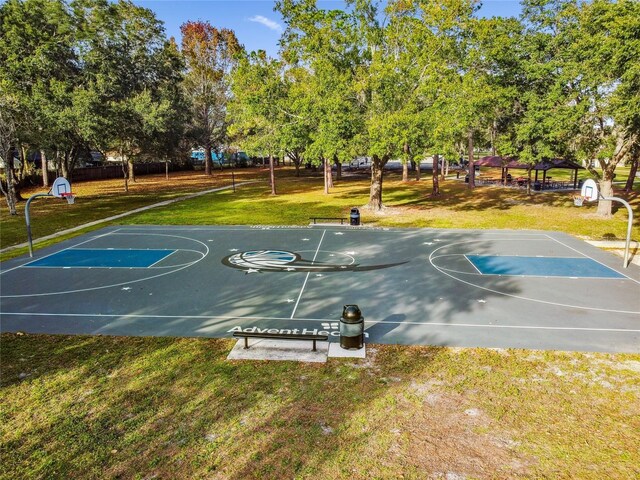 145 Lakeside Cir, Sanford, FL 32773 - view of sport court with community basketball court, a lawn, and view of wooded area