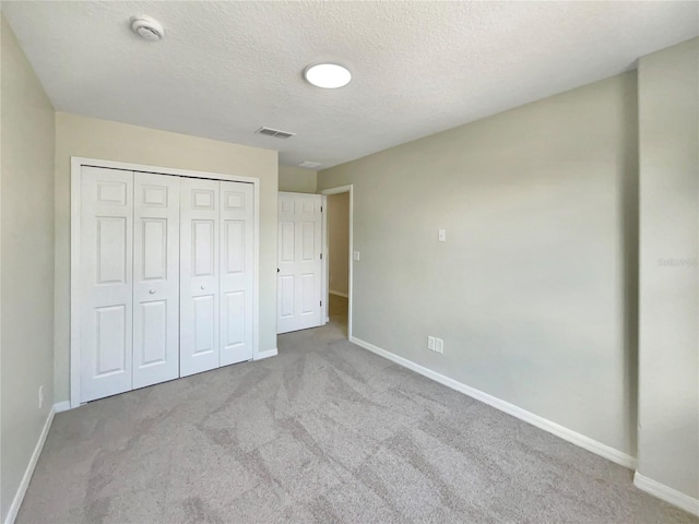 13108 Long Pine Trl, Clermont, FL 34711 - unfurnished bedroom featuring carpet flooring, a textured ceiling, and a closet