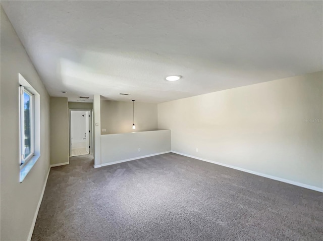 13108 Long Pine Trl, Clermont, FL 34711 - empty room featuring dark colored carpet and baseboards