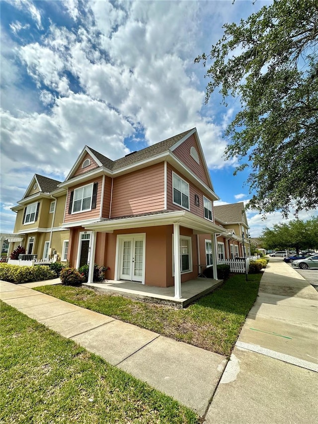 2200 San Vittorino Cir Unit 102, Kissimmee, FL 34741 - view of front facade featuring french doors, stucco siding, and covered porch