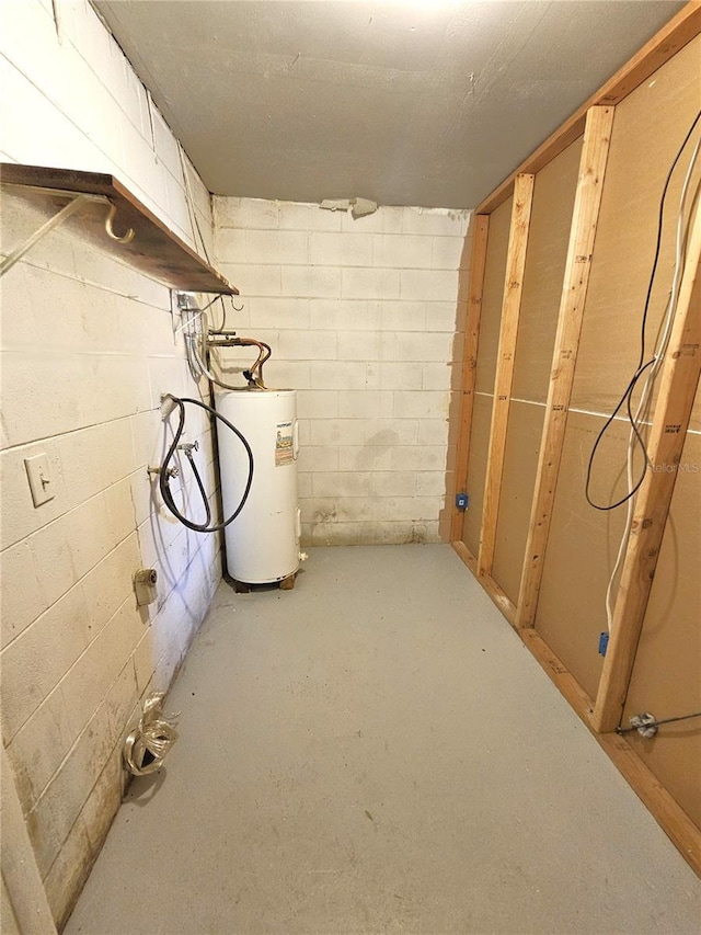 unfinished below grade area with water heater and concrete block wall