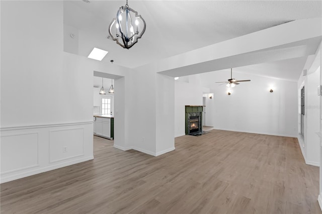 762 Lake Como Dr, Lake Mary, FL 32746 - unfurnished living room featuring a chandelier, light wood-style floors, a ceiling fan, and lofted ceiling