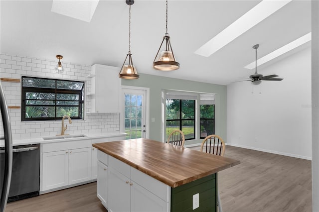 762 Lake Como Dr, Lake Mary, FL 32746 - kitchen featuring a skylight, dishwasher, wooden counters, backsplash, and vaulted ceiling