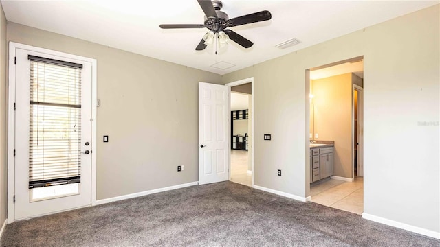 922 Suffolk Pl, Davenport, FL 33896 - unfurnished bedroom with light colored carpet, ensuite bath, and ceiling fan