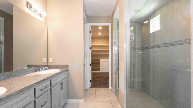 922 Suffolk Pl, Davenport, FL 33896 - bathroom with double vanity, a stall shower, a spacious closet, and tile patterned flooring