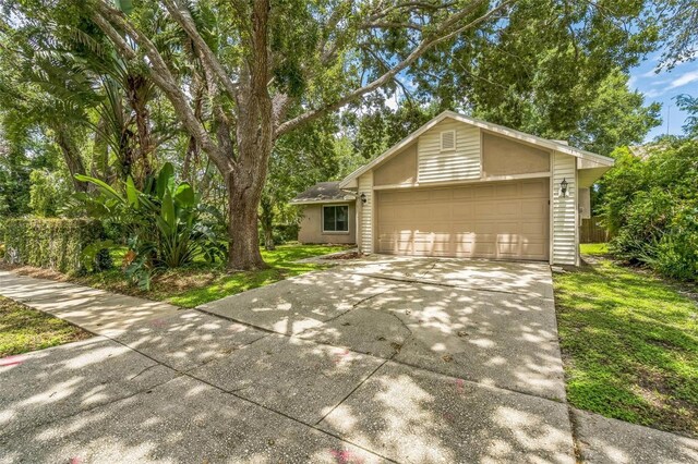 2002 Culpepper Dr, Brandon, FL 33511 - view of front of home with driveway, an attached garage, and a front yard